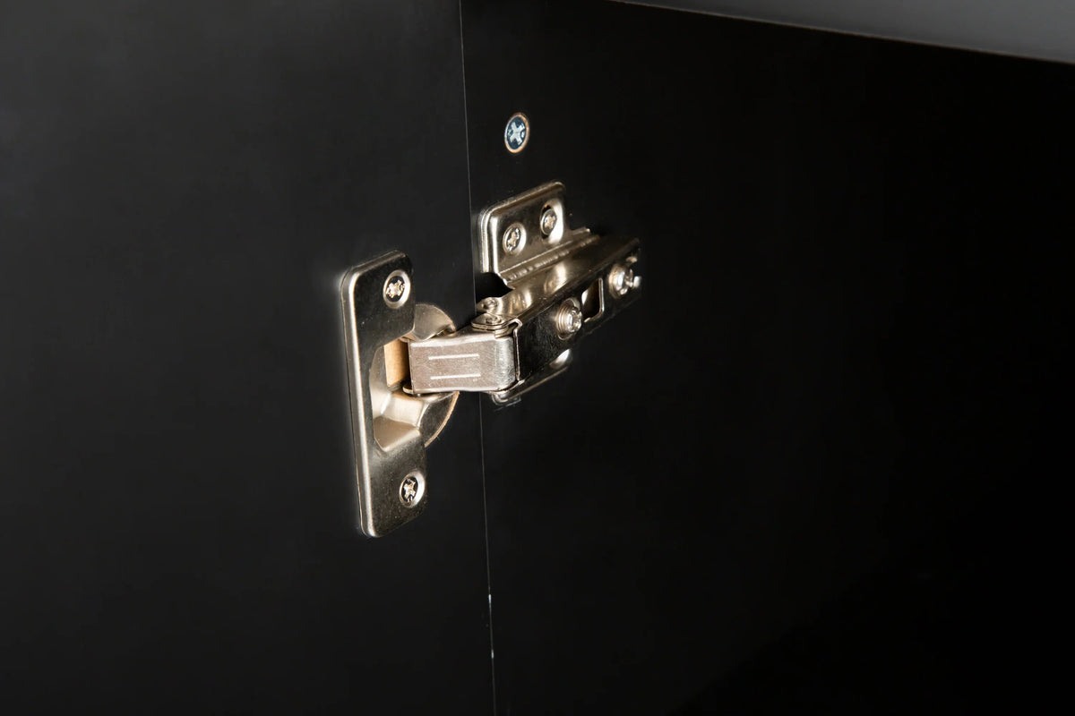 Close-up of a silver metal cabinet hinge installed on a black eprolo kitchen island cabinet.