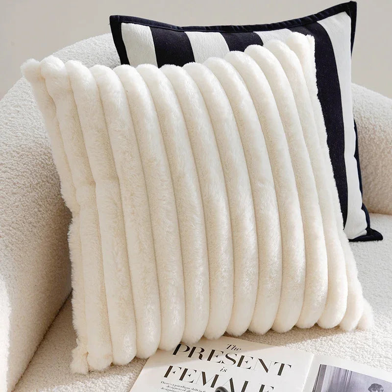 Cream textured ribbed faux fur pillow and black striped sofa cushion by eprolo