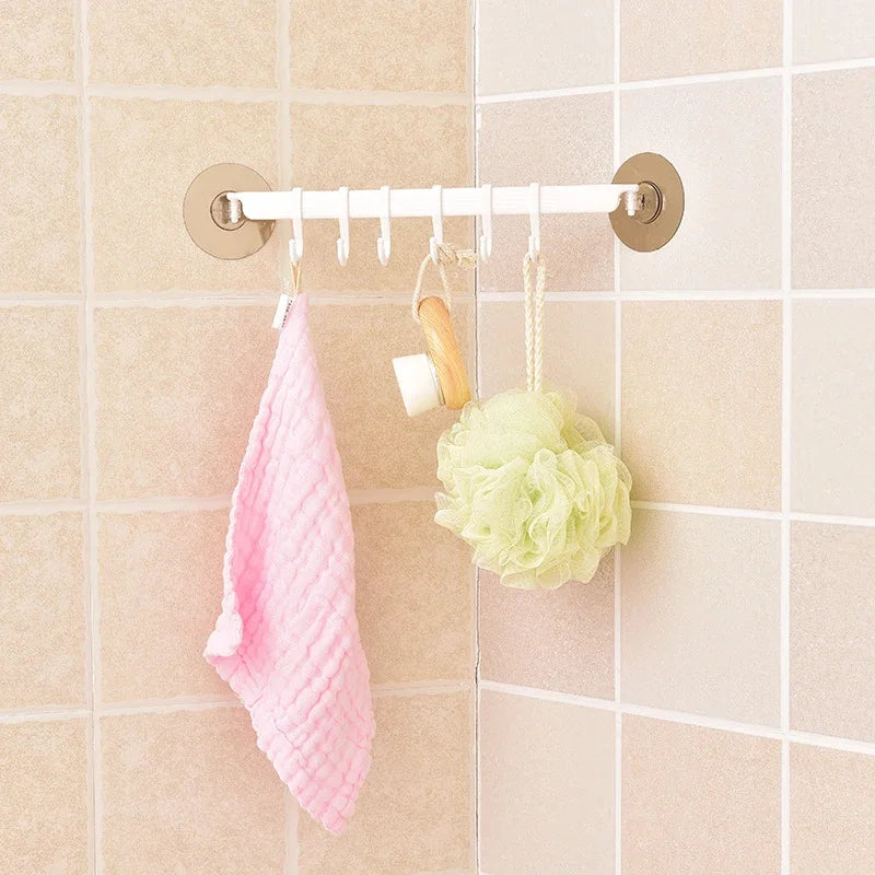 Eprolo nail-free adhesive wall hook holding a pink towel and bath sponge on tiled bathroom wall.