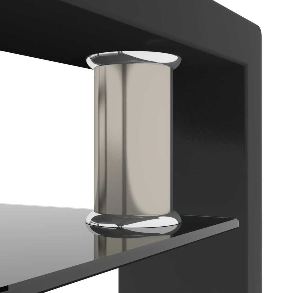 Modern silver cylindrical decorative ornament on a black glass coffee table.