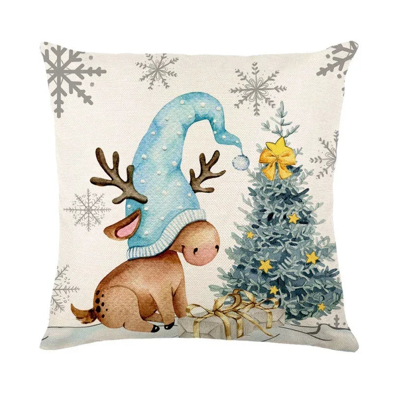 Christmas cushion cover featuring a cute reindeer with a blue hat and a decorated tree.