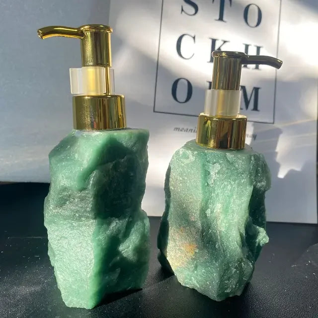 Two eprolo green natural crystal stone soap dispensers with gold pump heads for luxury bathroom decor.