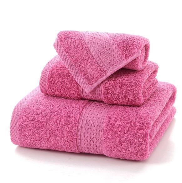 Set of three folded bright pink eprolo 100% cotton terry bath towels
