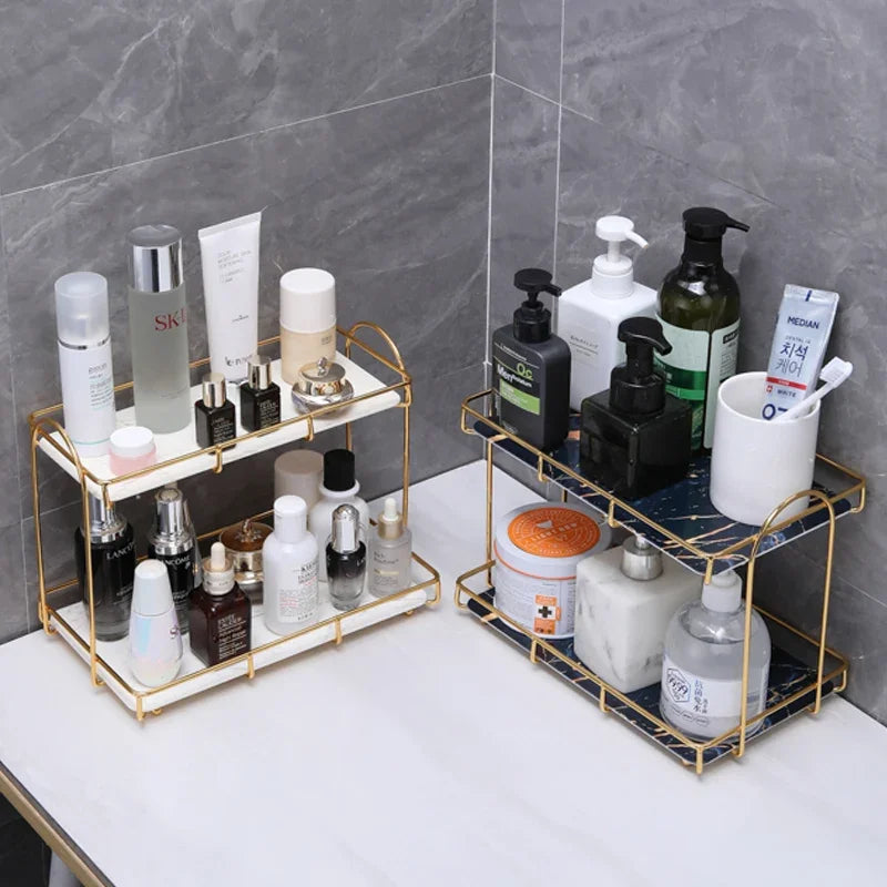 Golden double-layer iron cosmetic storage racks with skincare products on a marble surface.