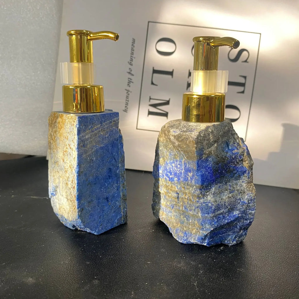 Two eprolo blue natural crystal stone liquid dispenser bottles with gold pumps.