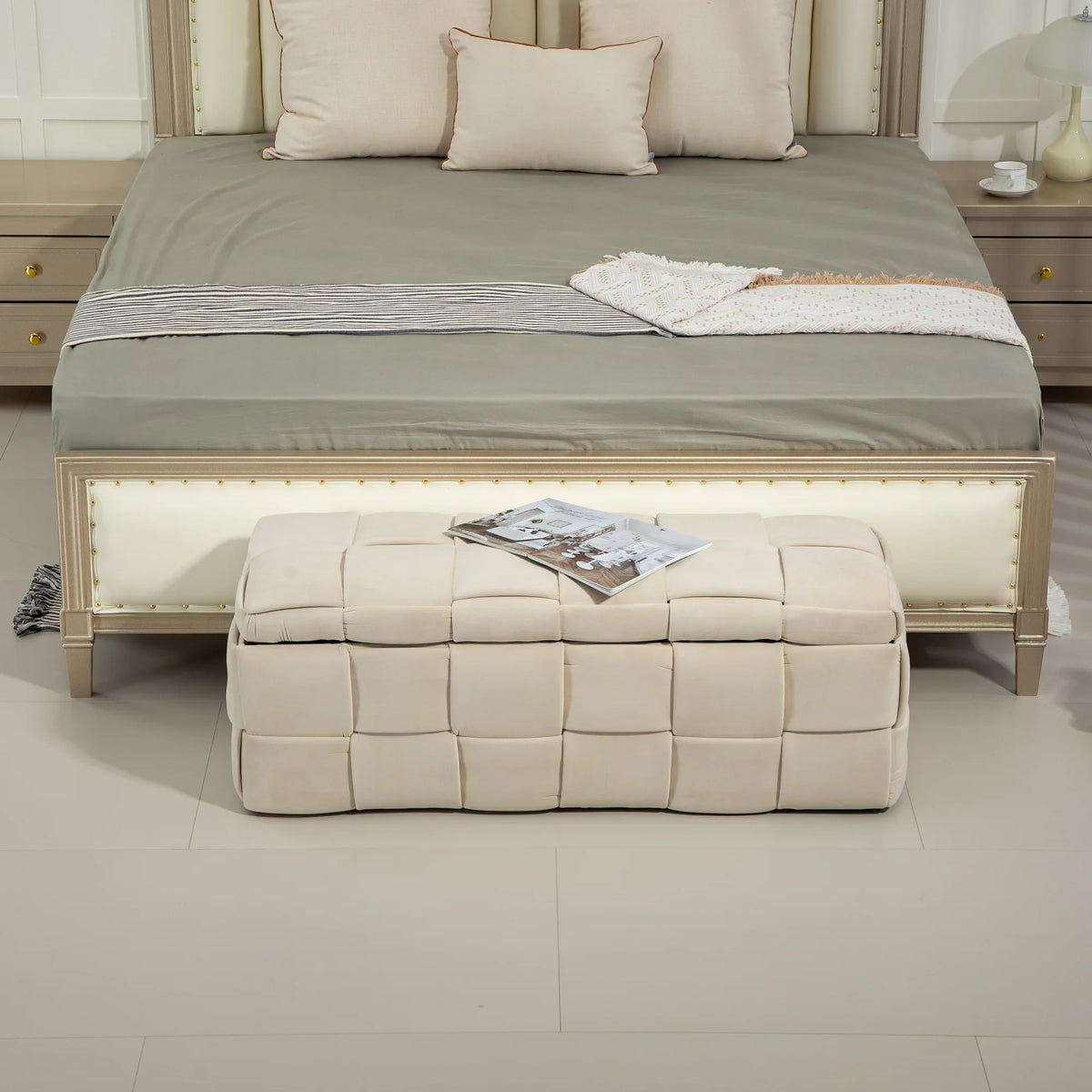 Beige eprolo cushioned fabric storage ottoman stool at the foot of a bed.