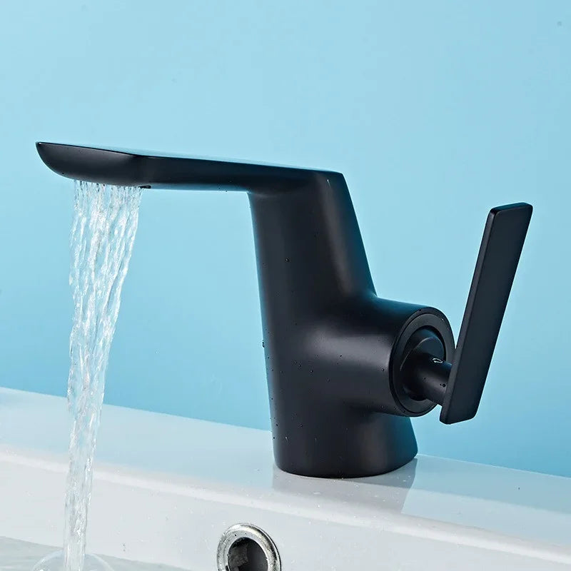 Modern matte black eprolo bathroom faucet with water running into a white sink.