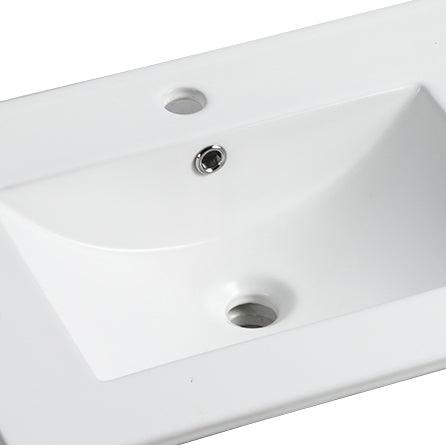 Close-up of a white eprolo 24 inch ceramic bathroom sink basin with chrome overflow and drain