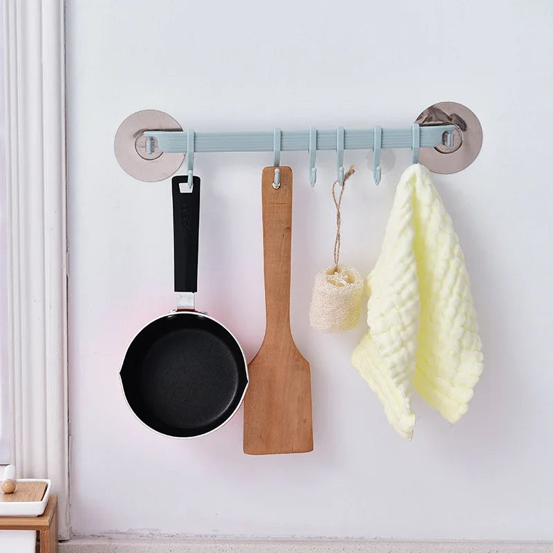 eProlo seamless nail-free kitchen wall hook rack holding a frying pan, spatula, and cloth