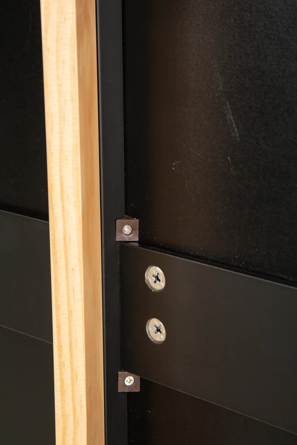 Close-up of the black metal frame and rubber wood countertop of an eprolo mobile kitchen island.