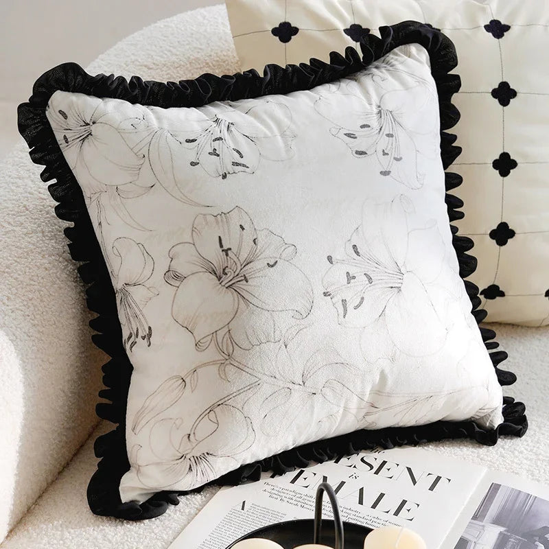White eprolo sofa pillow cover with black floral print and ruffled edges