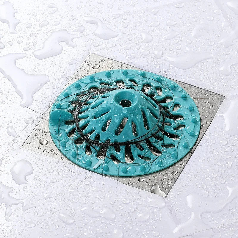 Teal volcano-shaped eprolo anti-clogging hair filter drain cover on a wet surface