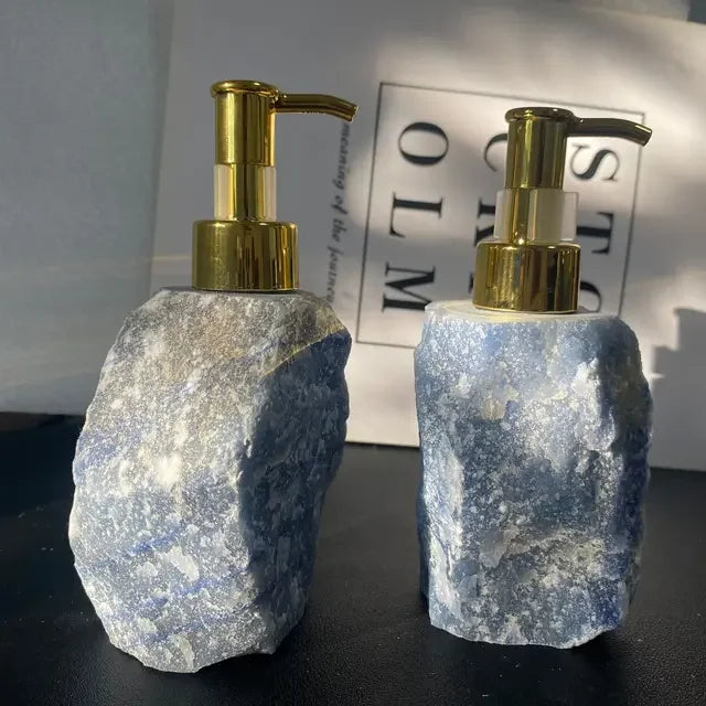 Two eprolo natural blue crystal stone soap dispensers with gold pump tops.