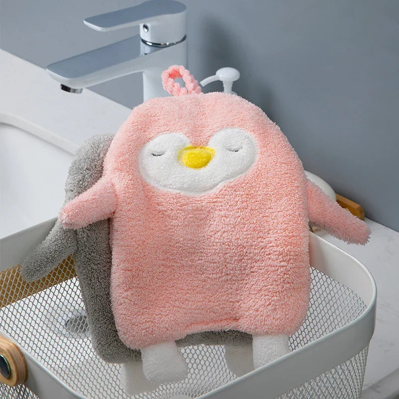 Cute pink penguin coral velvet absorbent hand towel by eprolo in a bathroom setting.