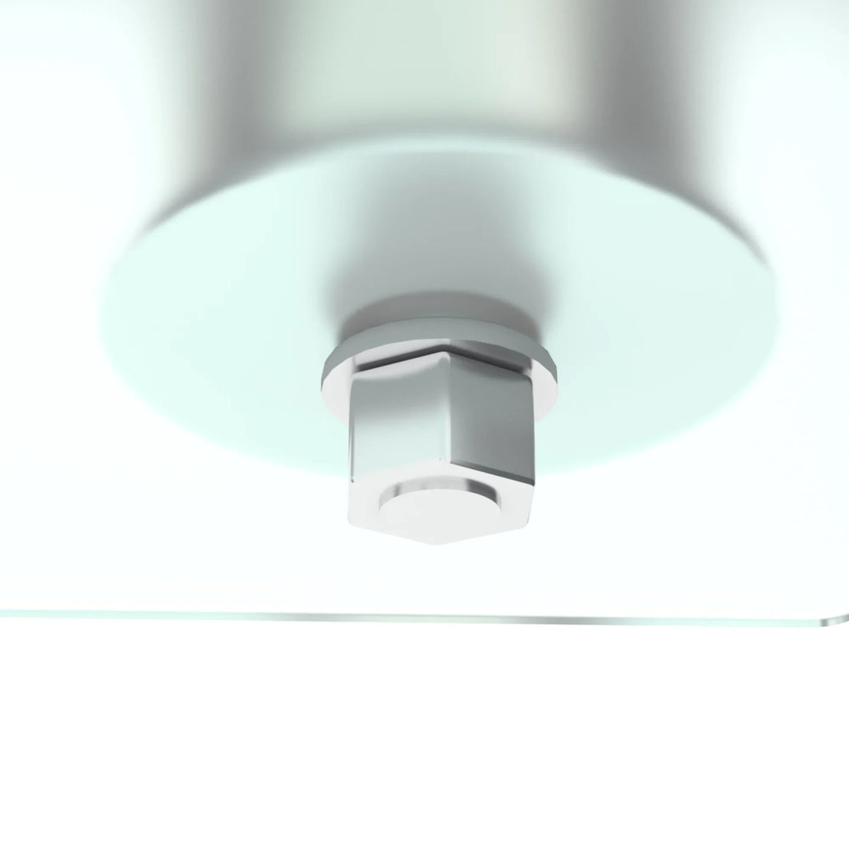 Close-up of a silver metal bolt fastener on a modern clear glass coffee table.