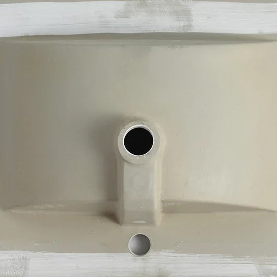 Close-up of the ceramic drain hole and overflow for an eprolo bathroom vanity top.