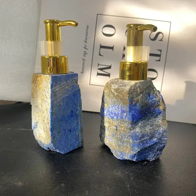 Two eprolo luxury blue lapis lazuli stone soap dispensers with gold pump heads.