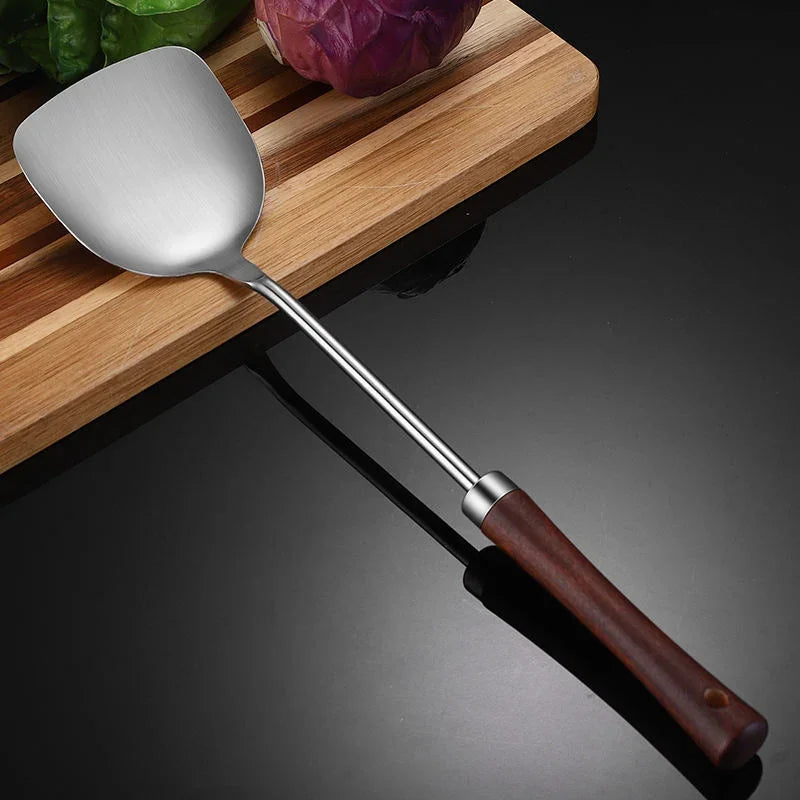 eprolo 304 stainless steel kitchen turner with wooden handle on a wooden cutting board