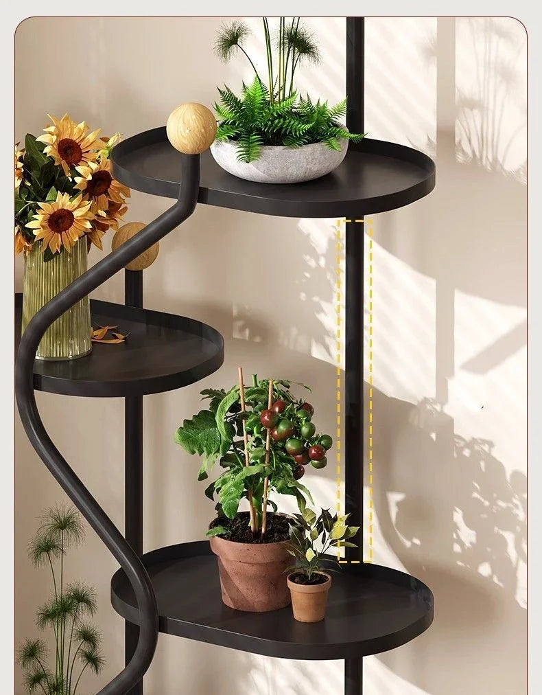 Modern black metal floor standing flower rack with potted plants and sunflowers.