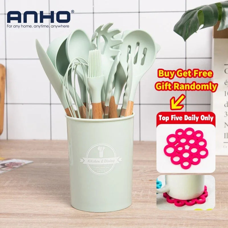 eProlo sage green silicone kitchen utensil set with wooden handles in a matching holder.