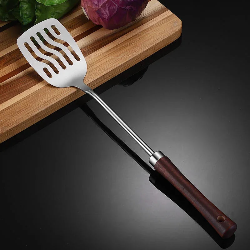 eprolo 304 stainless steel slotted spatula with wooden handle on a dark surface