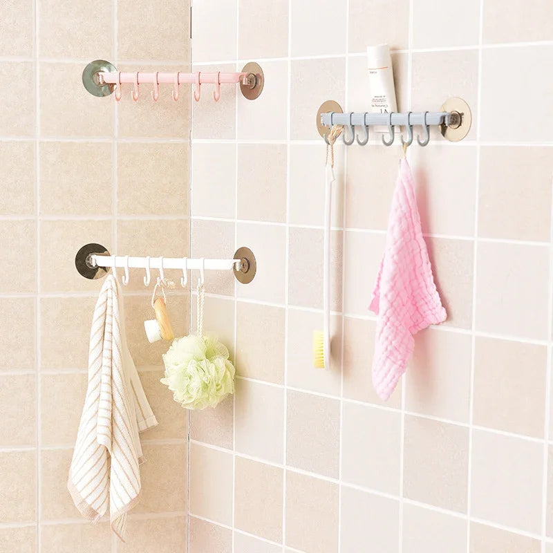 Three eprolo nail-free adhesive wall hooks in pink, white, and grey hanging bathroom accessories.