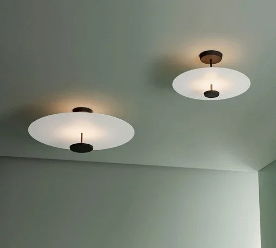 Two modern eprolo LED ceiling lights with white disc shades and black accents on a green ceiling