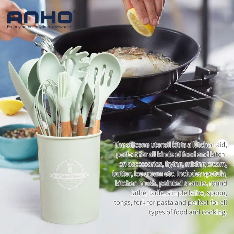 eprolo sage green silicone kitchen utensil set in a holder next to a frying pan.