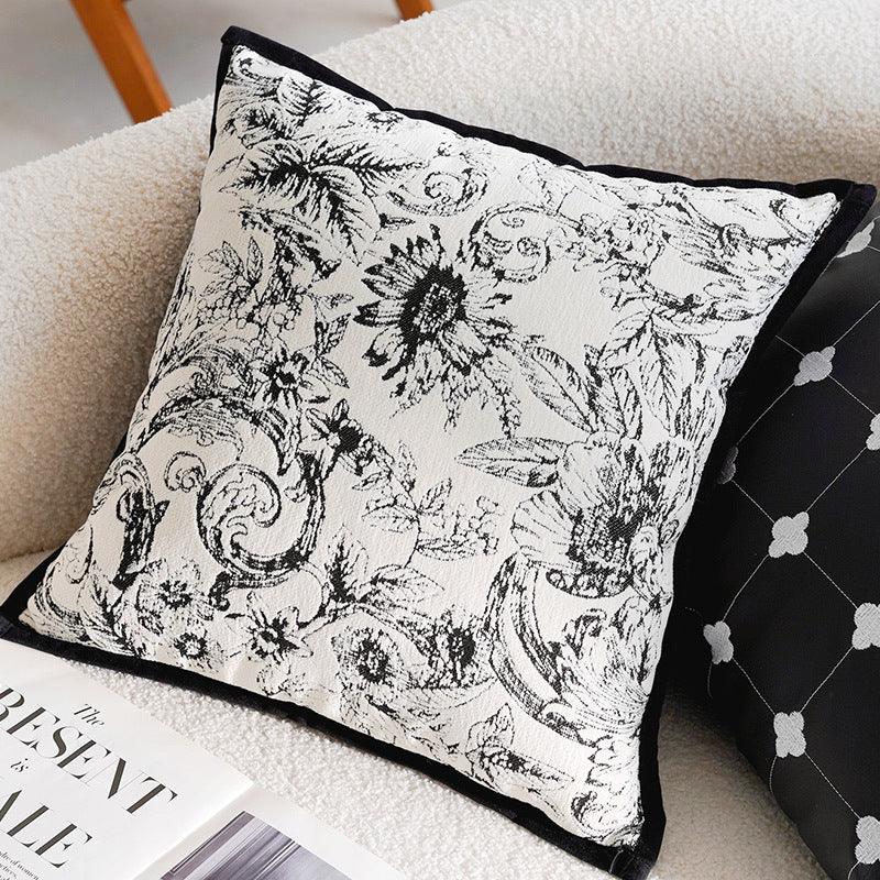 Black and white floral pattern sofa pillow cover by eprolo on a cream couch.