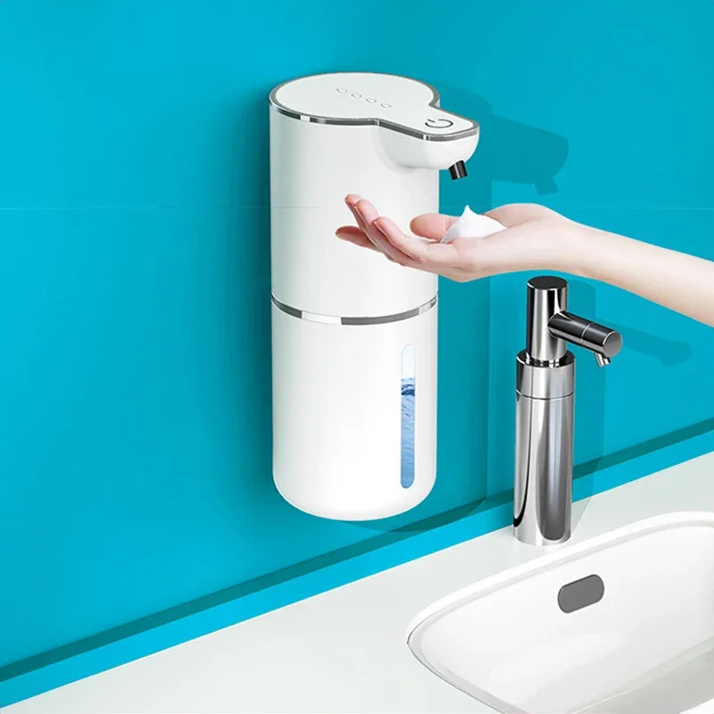 A hand receiving foam from an eprolo touchless sensor soap dispenser mounted on a blue wall.