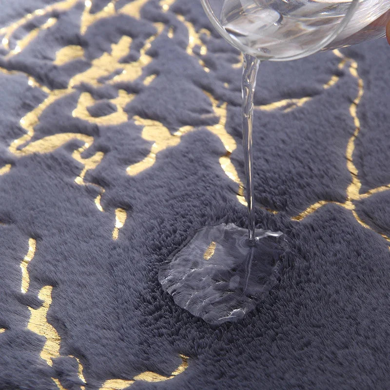 Water being poured onto a grey and gold faux fur absorbent bathroom mat.
