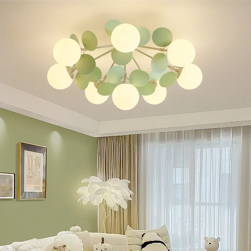 Eprolo magic bean ceiling light with round globe shades and green leaf accents in a bedroom.