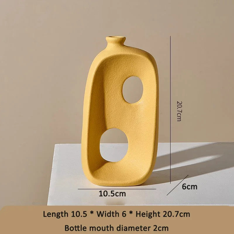 Modern yellow eprolo ceramic vase with abstract cut-outs and dimensions.