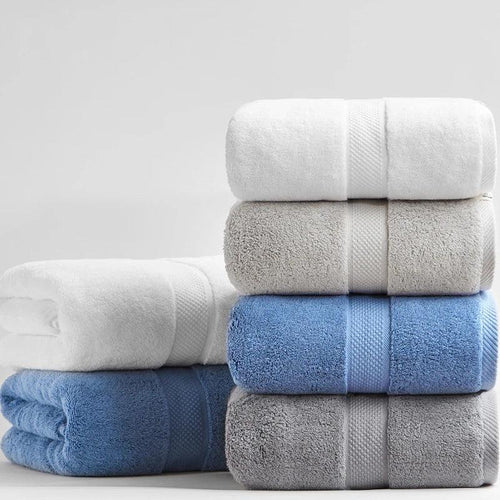 Stack of eprolo luxury 100% cotton bath towels in white, grey, and blue colors.