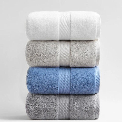 Stack of four luxury eprolo 100% cotton bath towels in white, beige, blue, and grey.