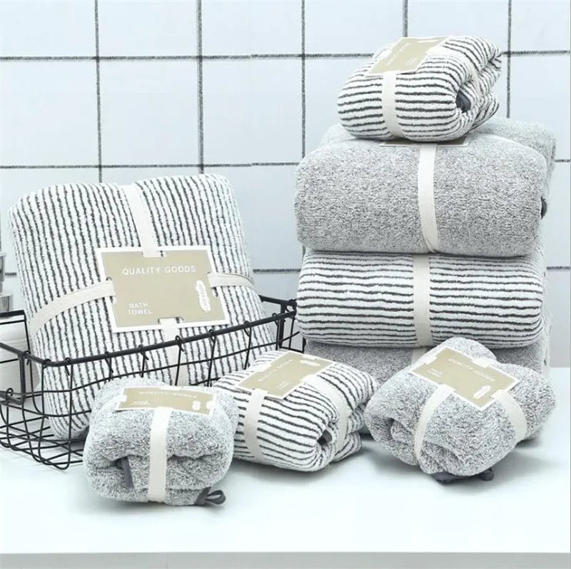 Stack of soft grey bamboo charcoal coral velvet bath towels by eprolo in a bathroom setting.