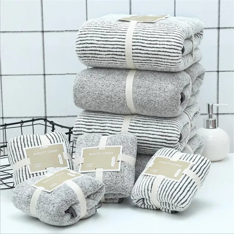 Stack of eprolo bamboo charcoal coral velvet bath towels in striped and grey patterns.