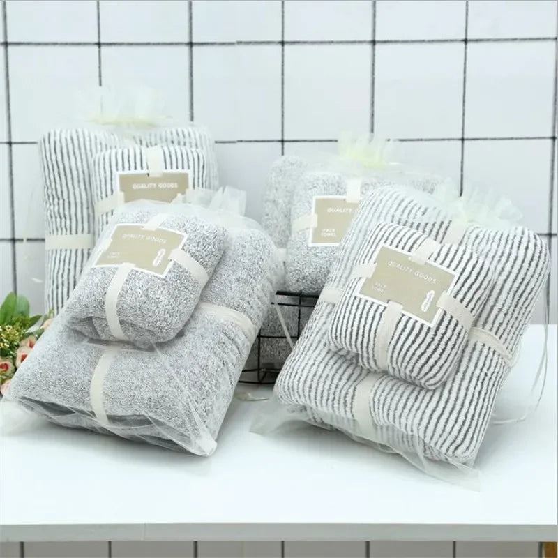 Set of eprolo bamboo charcoal coral velvet bath towels in striped patterns.